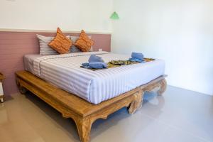 a bed with two blue towels on top of it at My Home Lantawadee Resort in Ko Lanta