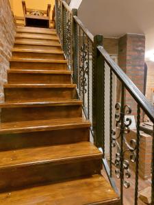 a staircase with wooden steps and a brick wall at Zlatibor Cottages in Zlatibor