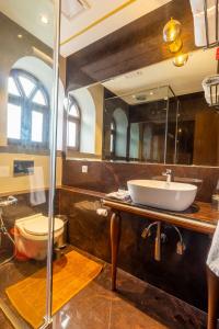 a bathroom with a sink and a toilet at R R Heritage Resort Pure Vegetarian in Mahabaleshwar