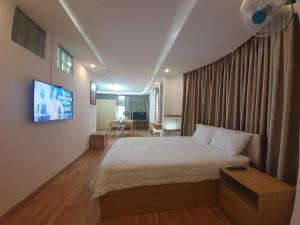 a bedroom with a bed and a flat screen tv at City Backpackers Hostel in Ho Chi Minh City