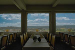 a dining room table with two chairs and a window at Hotel-Restaurant Burg Hornberg in Neckarzimmern