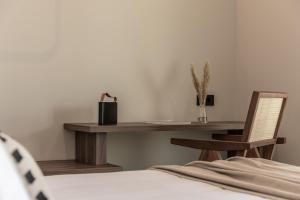 a bedroom with a desk and a chair and a bed at AKU Suites with private pools in Stalís +21 photos