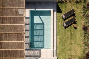 an overhead view of a swimming pool in a yard at AKU Suites with private pools in Stalís