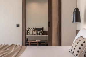a bedroom with a mirror and a bed at AKU Suites with private pools in Stalís
