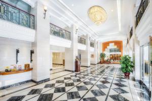 a lobby of a building with a black and white tiled floor at Hotel Sintra in Macau