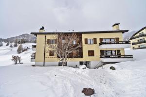 a large building in the snow with snow around it at Chesa Murtiroel - Samedan in Samedan