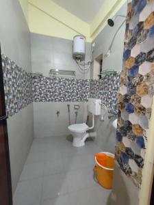 a bathroom with a toilet and a sink at Casa De Olga in Vagator