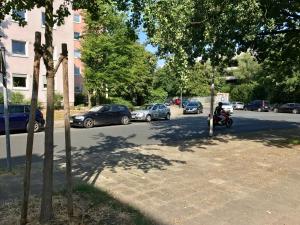 a person riding a motorcycle on a street with cars at Big Und Nice 3 Bedrooms in Hannover