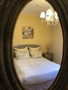 a bedroom with a large bed in a mirror at Hotel La Regence in Villefranche-sur-Mer