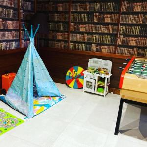 a room with a tent and a table in a library at Hotel La Regence in Villefranche-sur-Mer