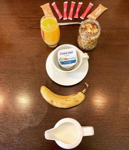 a table with a plate of breakfast food and a banana at Hotel La Regence in Villefranche-sur-Mer