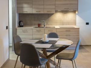 a dining room table and chairs in a kitchen at La Maison de Papagran CIR Charvensod-0007 in Aosta +9 photos