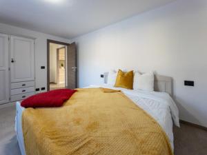 um quarto com uma cama grande com um cobertor amarelo em La Maison de Papagran CIR Charvensod-0007 em Aosta