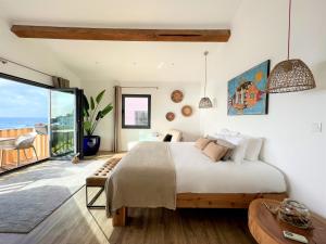 a bedroom with a bed and a view of the ocean at VILLA SAL in Lagoa