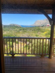 a porch with a view of a field and mountains at Adorable 2 bedroom seaside vacation home in Kleinmond