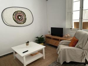 a living room with a couch and a coffee table at Casa Olivera- apartament al Passeig Font Vella in Sant Hilari Sacalm