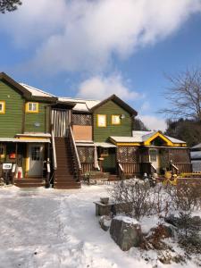 a house with snow in front of it at Mayfair Rodemtree Pension in Pyeongchang 