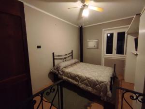 a bedroom with a bed and a ceiling fan at Dentro il Borgo in Perugia