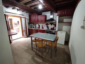 a kitchen with a table and chairs in a room at Dentro il Borgo in Perugia