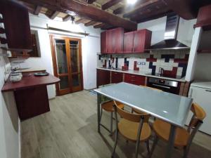 a kitchen with a table and chairs in a room at Dentro il Borgo in Perugia +5 photos