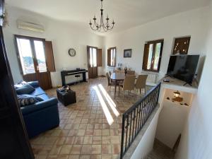 a living room with a couch and a dining room at Adamas Domus in Taormina