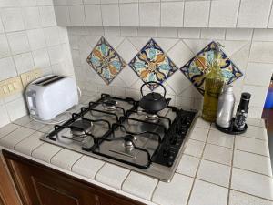 a kitchen stove with a tea pot on it at Adamas Domus in Taormina +24 photos