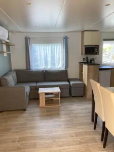 a living room with a couch and a table at Vue Mer in Quiberon