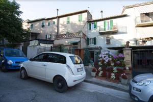 a white car parked on the side of a street at Dentro il Borgo in Perugia