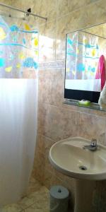 a bathroom with a shower curtain and a sink at Chácara Refugio das Maritacas Itu in Itu