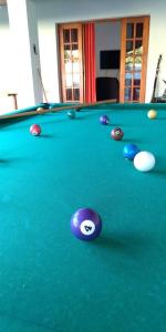 a pool table with balls on top of it at Chácara Refugio das Maritacas Itu in Itu