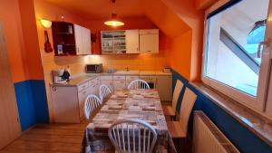 a small kitchen with a long table and chairs at Valant Apartment ID I00070 in Bled
