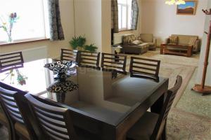 a living room with a dining table and chairs at Space Grey Villa - Вилла с 5 спальнями в центре Цахкадзора in Tsaghkadzor
