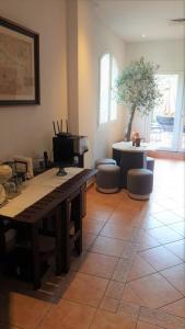 a living room with a table and a piano at Cherrywood House in Dubai +8 photos
