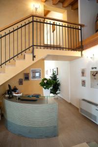 an office with a staircase and a lobby with a desk at Villa Myosotis in Mirano
