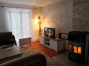 a living room with a living room with a fireplace at Vikendica Ajla in Travnik