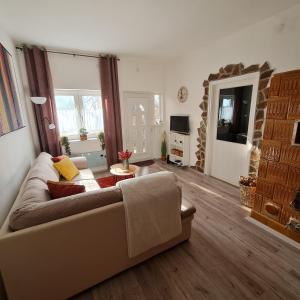 a living room with a couch and a table at Het Romeo & Julia Huisje in Babarc +26 photos