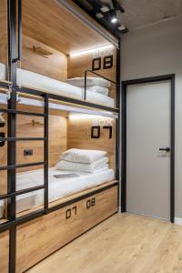 a room with three bunk beds with a door at VIA Hostel in Kazan