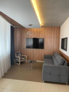 a living room with a couch and a flat screen tv at Leo lux 1 in Niš