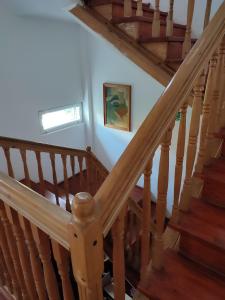 a staircase in a house with a wooden stair case at Vila Brazilor in Caciulata