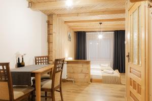 a dining room with a table and chairs at Chata u Bronka in Białka Tatrzanska