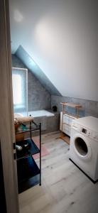 a laundry room with a washing machine and a staircase at Apartament u Edka przy Dolnej II in Świeradów-Zdrój