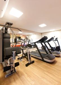 a gym with a bunch of exercise bikes in a room at San Diego Suites Veredas Sete Lagoas in Sete Lagoas