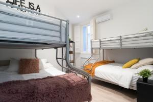 a bedroom with two bunk beds in a room at PLAZA MAYOR groups by MONARO***** in Madrid