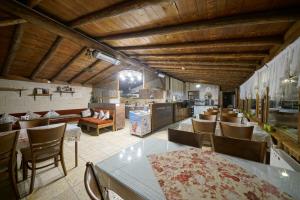 a restaurant with tables and chairs and a kitchen at Arch Palace in Göreme