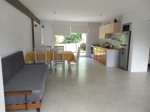 a kitchen and dining room with a table and a refrigerator at La Isla Ostende in Ostende