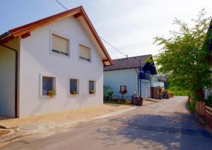 a white house with windows on a street at ECO-LUX APART with free bicycles end free parking in Ljubljana