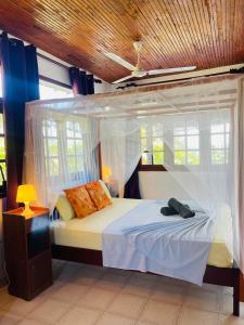 a bedroom with a bed with a canopy at Bougain Villa Sea View in Mirissa