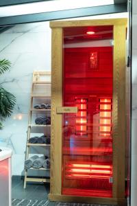 a red refrigerator in a room with a shelf at IN LUX SPA APARTMAN in Vrnjačka Banja