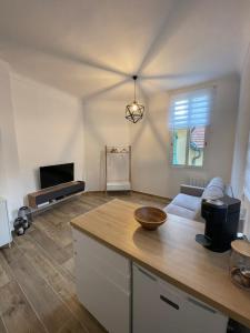 a kitchen and living room with a wooden counter top at Monaco Cosy Studio in Roquebrune-Cap-Martin