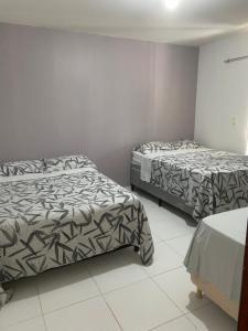 a bedroom with two beds in a room at Flat 09 in Conde
